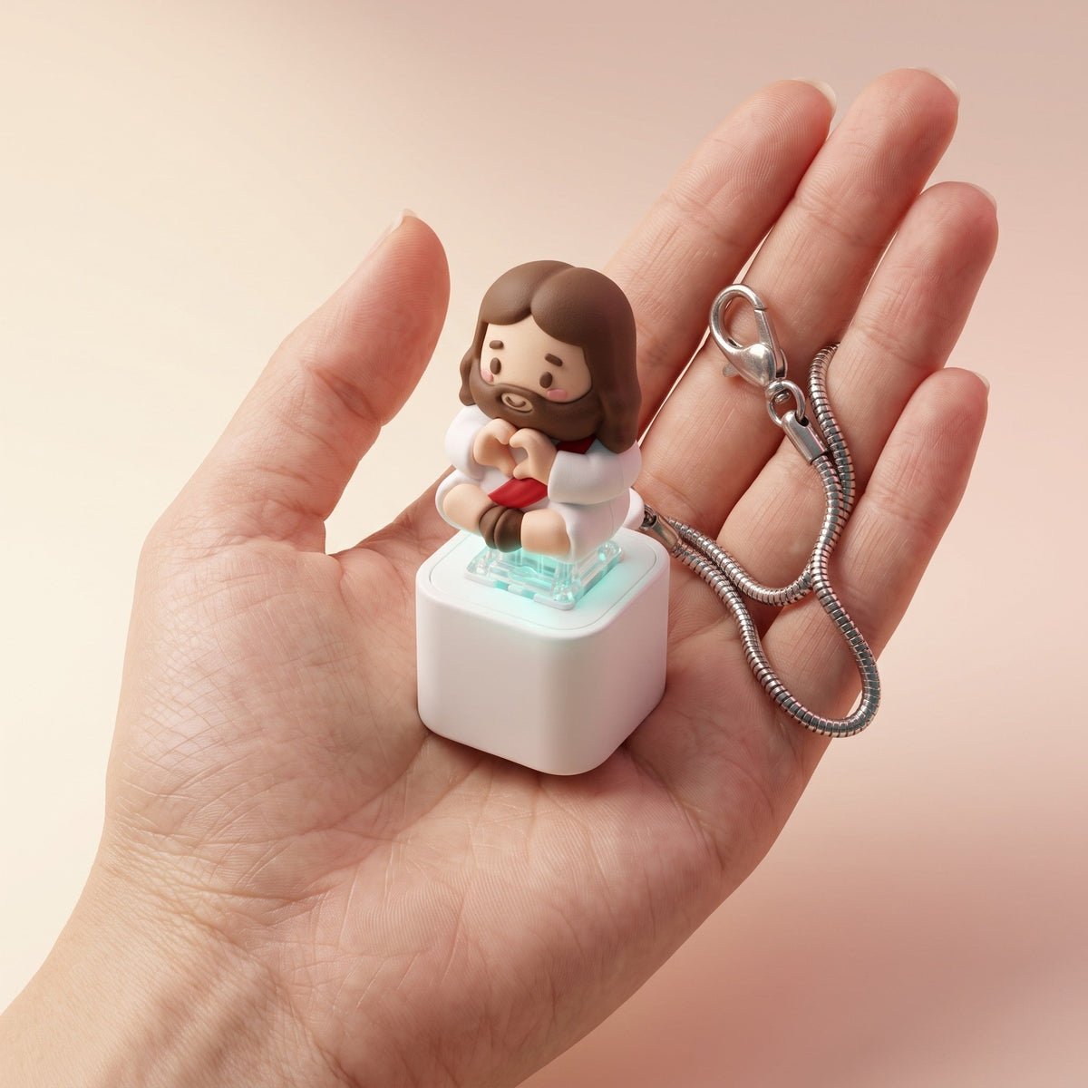 Clicky Jesus keychain resting in a palm for size reference